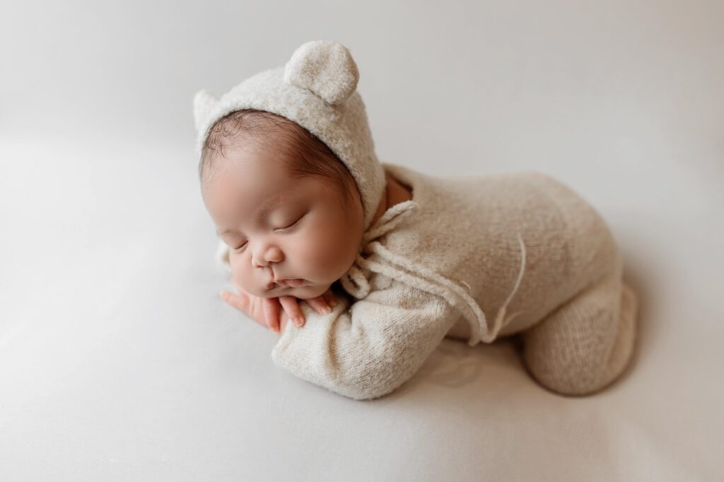 Cute newborn baby girl in white outfit for Muslim baby name article