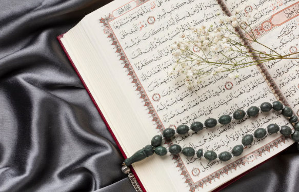 Islamic new year decoration with praying beads on quran